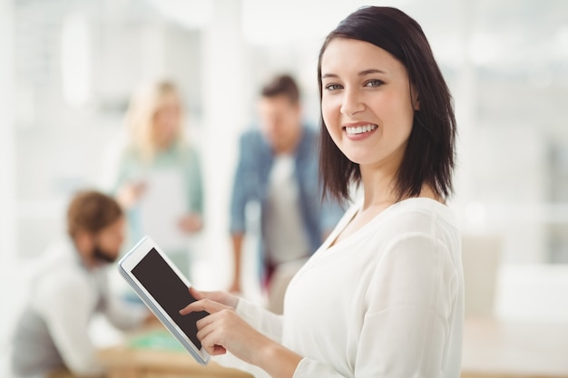 Portrait of smiling woman using digital tablet 