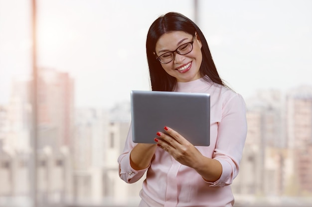 Portrait of smiling young asian businesswoman with glasses