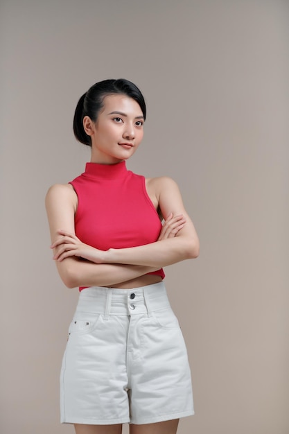 Portrait smiling young asian woman with crossed arms