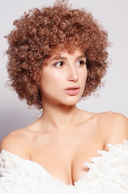 Portrait of smiling young black woman. Portrait of a beautiful young woman with African American afro haircut and glamor makeup. Studio shot. Attractive girl wearing eyeglasses.