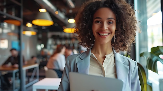 Portrait of smiling young businesswoman using digital tablet while sitting in cafe