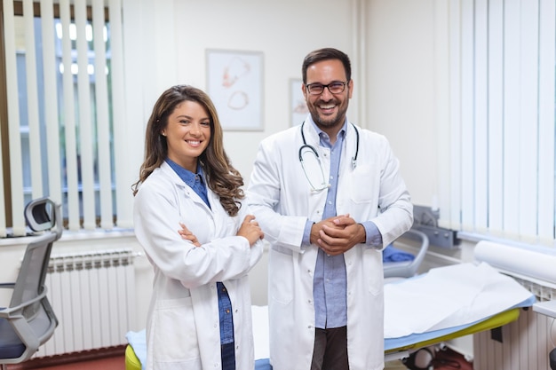 Portrait of smiling young doctors standing together Portrait Of Medical Staff Inside Modern Hospital Smiling To Camera