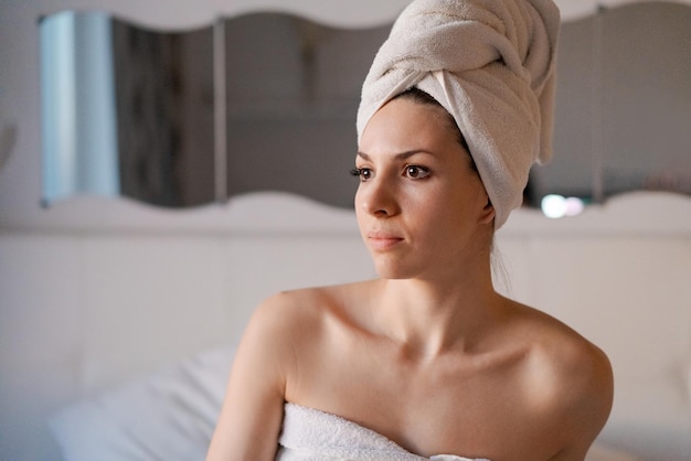 Portrait smiling young European brunette woman enjoying her spa in evening