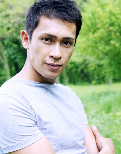 Portrait of a smiling young man in nature