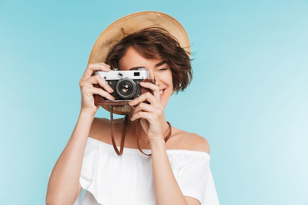 Portrait of a smiling young woman in summer hat