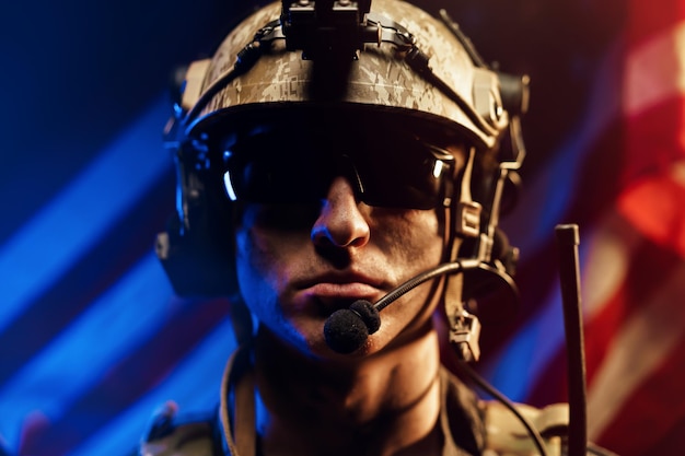 Portrait of special forces soldier in glasses and helmet against us national flag