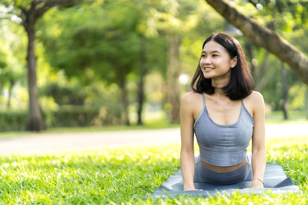 Portrait sport asian beauty body slim woman in sportswear sitting relax and girl practicing yoga and do fitness exercise in park at homeDiet conceptFitness and healthy