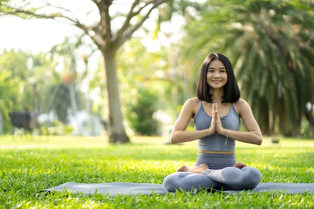 Portrait sport asian beauty body slim woman in sportswear sitting relax and girl practicing yoga and do fitness exercise in park at homeDiet conceptFitness and healthy