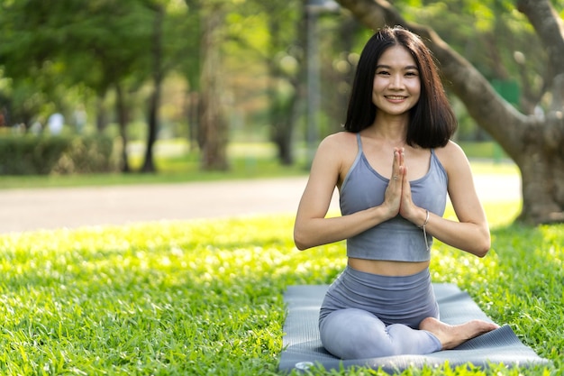 Portrait sport asian beauty body slim woman in sportswear sitting relax and girl practicing yoga and do fitness exercise in park at homeDiet conceptFitness and healthy