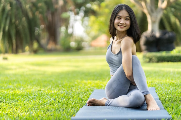 Portrait sport asian beauty body slim woman in sportswear sitting relax and girl practicing yoga and do fitness exercise in park at homeDiet conceptFitness and healthy