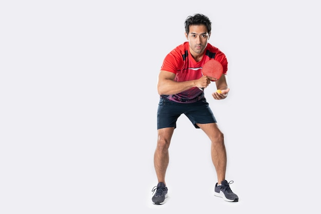 Portrait of sports man male athlete playing table tennis isolated