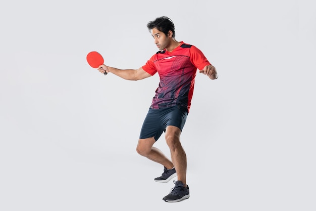 Portrait of sports man male athlete playing table tennis isolated