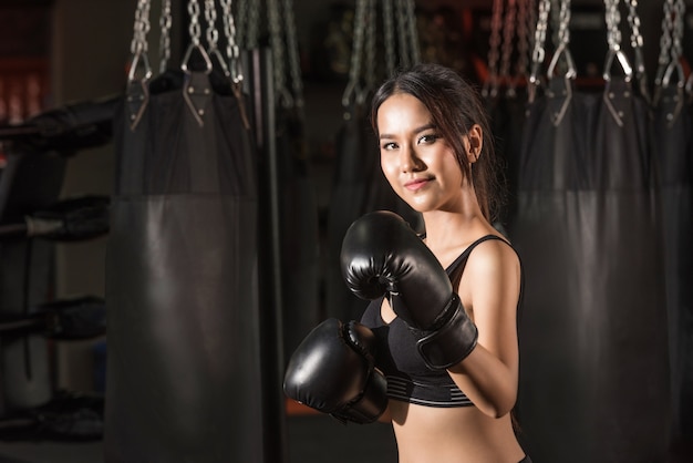 Portrait of sporty fit Asian model of boxing gym