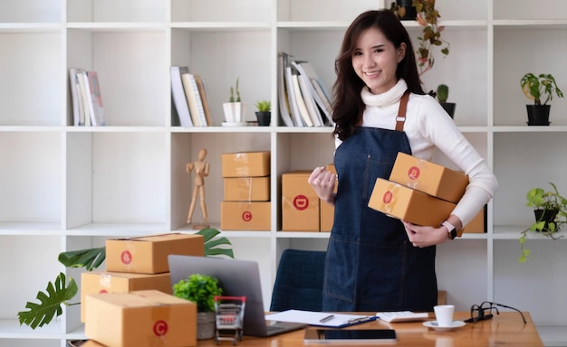 Portrait of Starting small businesses SME owners female entrepreneurs working on receipt box and check online orders to prepare to pack the boxes sell to customers sme business ideas online