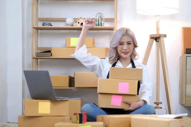 Portrait of Starting small businesses SME owners female entrepreneurs working on receipt box and check online orders to prepare to pack the boxes sell to customers SME business ideas online