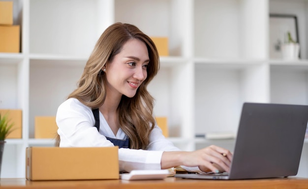 Portrait of Starting small businesses SME owners female entrepreneurs working on receipt box and check online orders to prepare to pack the boxes sell to customers sme business ideas online