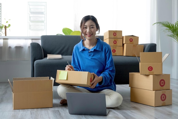 Portrait of Starting small businesses SME owners female entrepreneurs working on receipt box and check online orders to prepare to pack the boxes sell to customers sme business ideas onlinexA