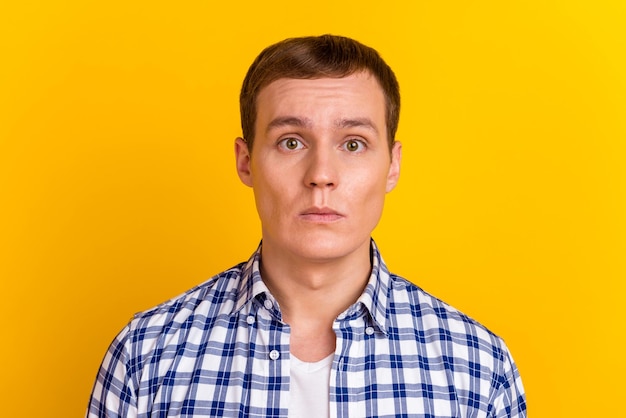 Portrait of strict successful guy look in camera isolated on yellow color background