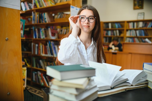 Portrait of a student girl studying at library