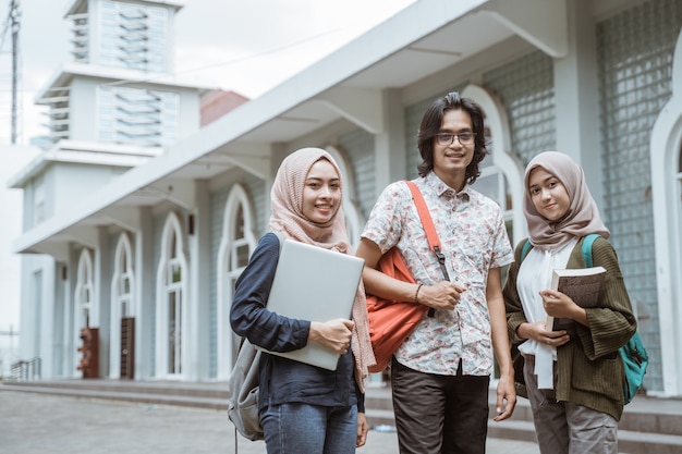 Portrait of students looking at the front on the campus yard.