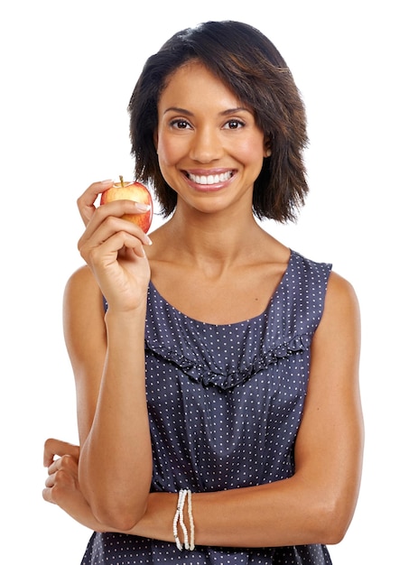 Portrait studio or black woman eating an apple against a white background with marketing mockup space Fruit organic or happy African girl advertising healthy food or diet for self care or wellness