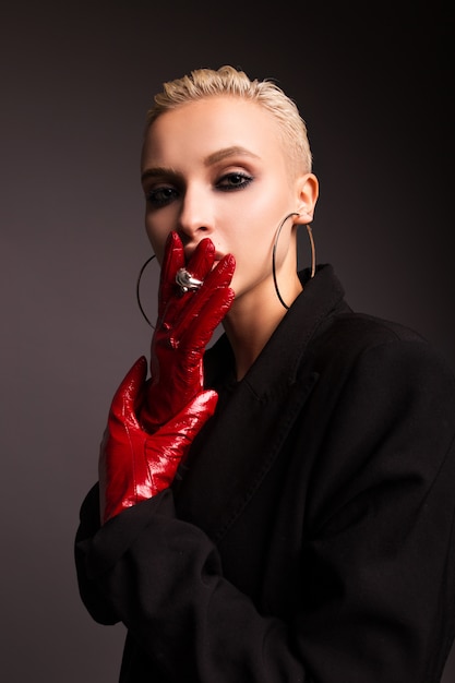 Portrait of a stylish blonde with red leather gloves