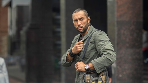 Portrait of stylish middle aged man with bag in the street life style