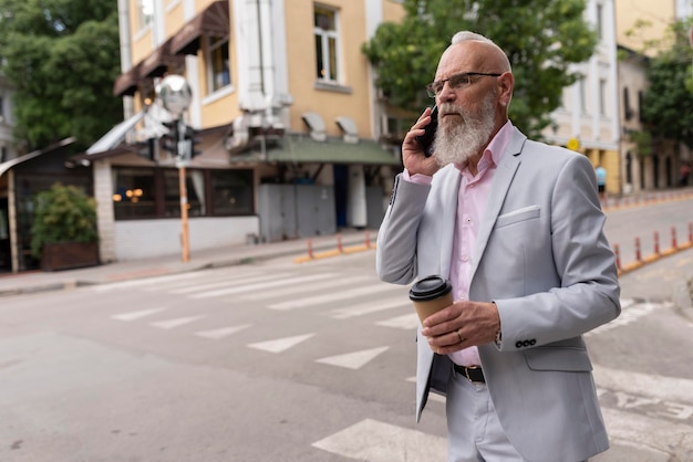 Portrait of stylish senior man speaking on the phone