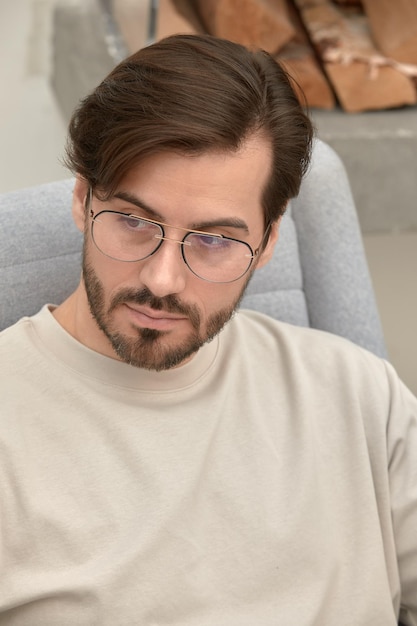 Portrait of a stylish successful young man in glasses young brunette businessman in glasses stylish portrait of a young man