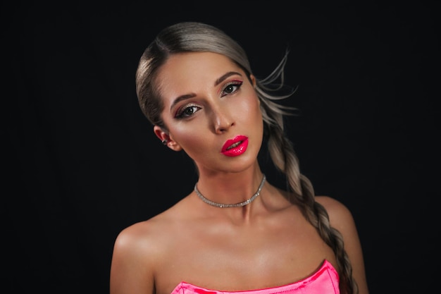 Portrait of a stylish young woman with a platinum blonde hairstyle and perfect makeup A fashionable model girl with perfect skin and trendy pink lips