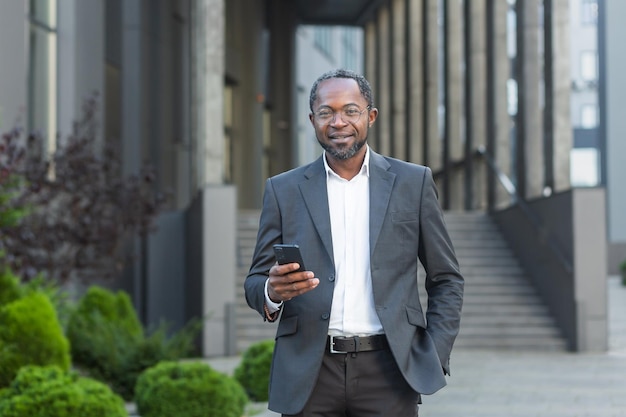 Portrait of a successful african american male attorney lawyer who is standing in glasses and a suit