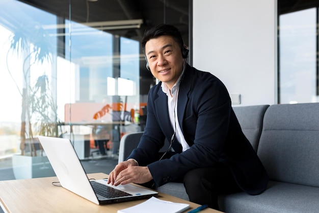 Portrait of a successful Asian businesswoman man looking at camera and smiling Call center employee smiling and rejoicing