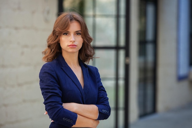 Portrait of a successful business woman in front of modern business building Young manager outside