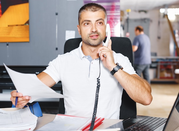 Portrait of successful Businessman entrepreneur working at busy office