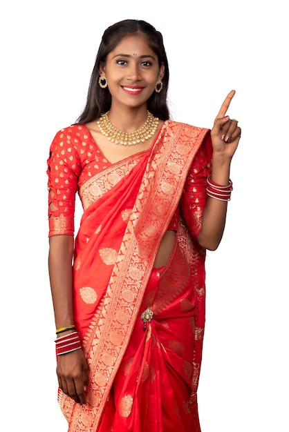 Portrait of a successful cheerful young girl pointing and presenting something with a hand or finger with a happy smiling face