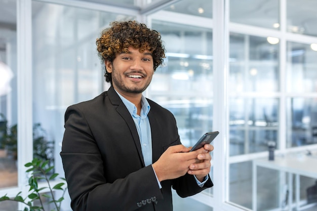 Portrait of successful hispanic businessman investor man smiling and looking at camera boss in suit