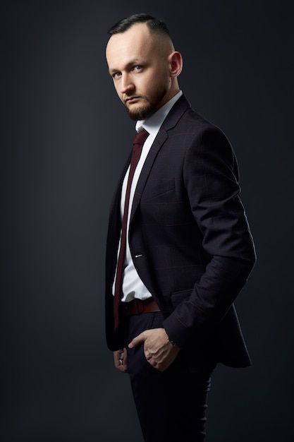 Portrait of a successful male businessman on a dark background