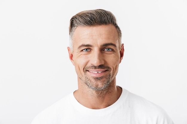 Portrait of successful man 30s with bristle wearing casual t-shirt smiling isolated on white