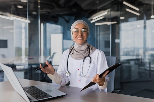 Portrait of successful muslim female doctor in hijab arabic woman working in modern clinic office