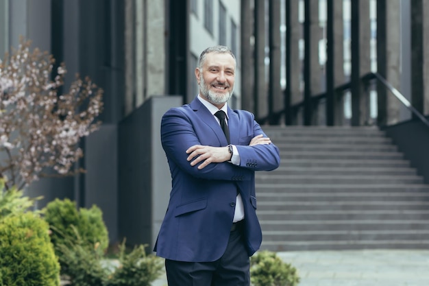 Portrait of a successful senior male businessman in a business suit and tie standing confidently