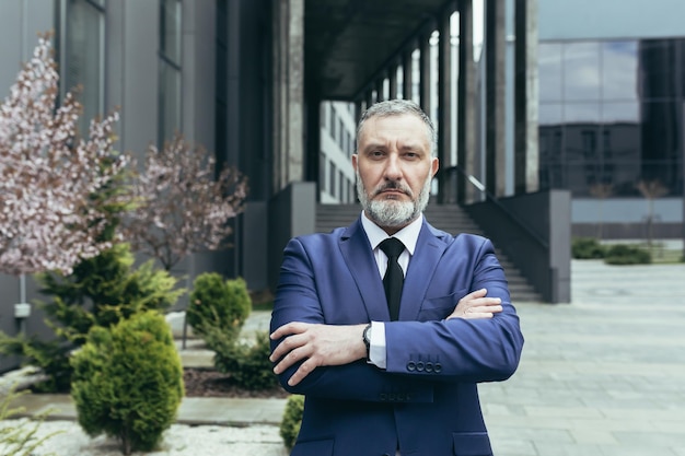 Portrait of successful thinking experienced senior businessman gray haired male boss in business