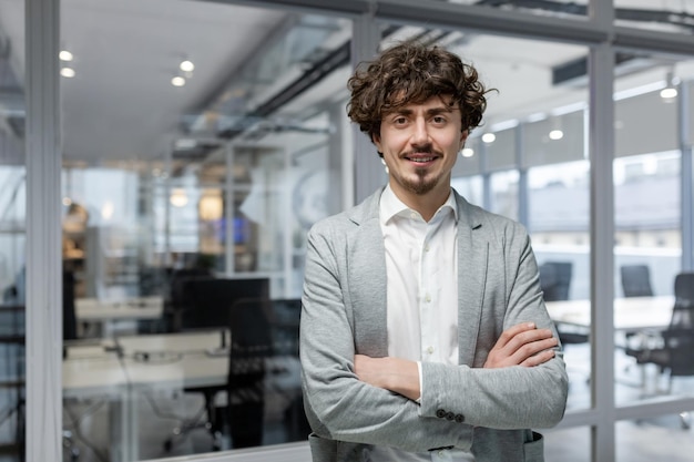 Portrait of successful young boss businessman in business suit looking at camera and smiling man