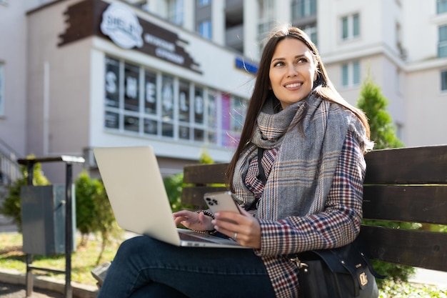 Portrait of a successful young business woman working online on a laptop with a cup of coffee and