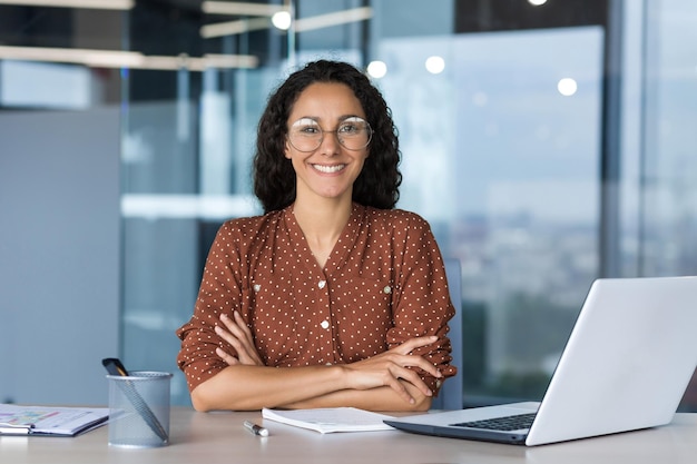 Portrait of successful young businesswoman hispanic woman working inside modern office building