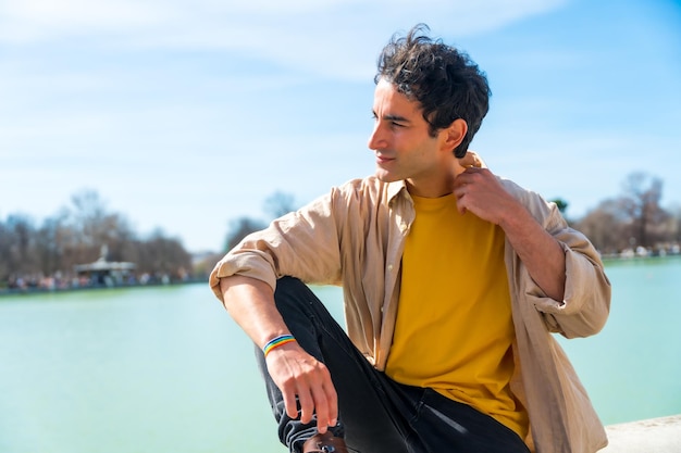 Portrait of a summer caucasian young man in a city lake enjoying the summer on vacation