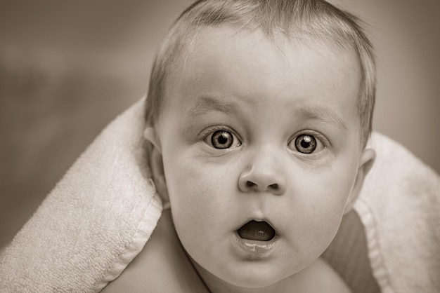 Portrait of surprised cute baby boy sepia tone