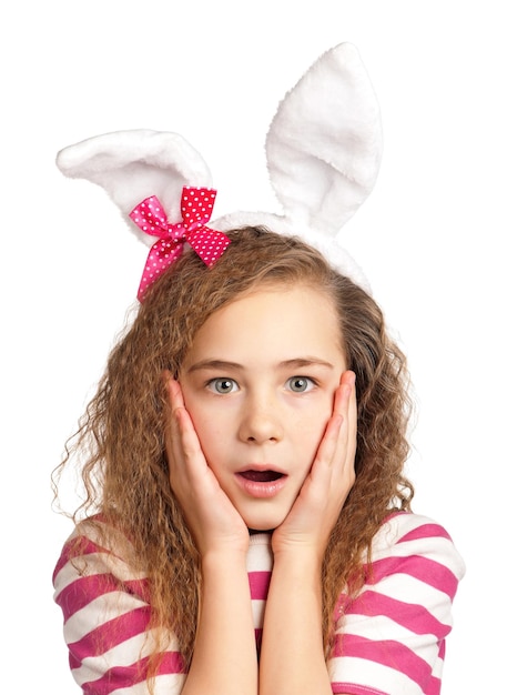 Portrait of surprised girl with bunny ears isolated on white background