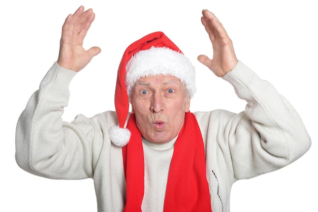 Portrait of surprised senior man in Santa hat