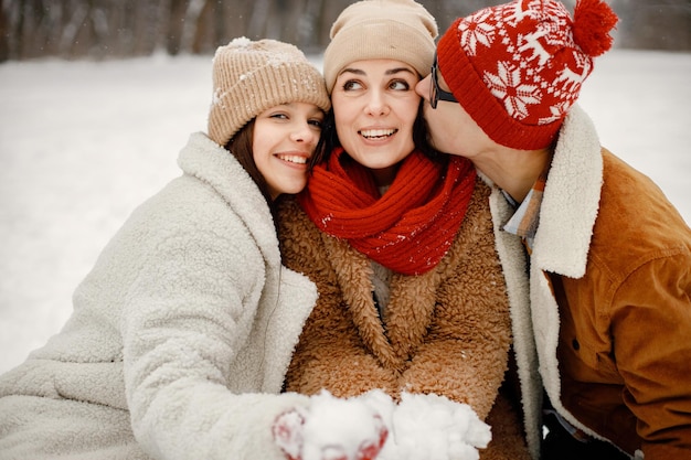 Portrait of teen siblings and their mother at winter park