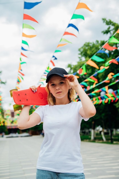 Portrait of a teenage girl in casual clothes Summer skateboarding active lifestyle A student or a student on summer vacation Sports activities